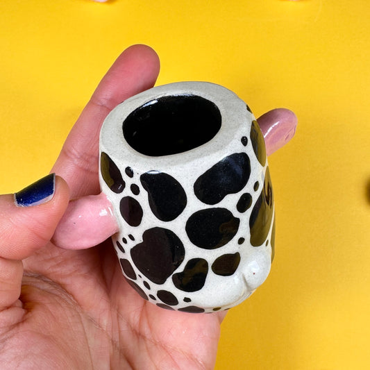Speckled miniature candle holder with a little butt
